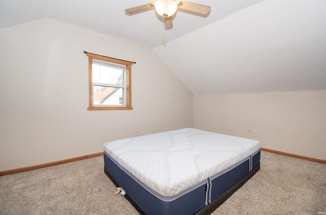 carpeted bedroom with lofted ceiling, ceiling fan, and baseboards