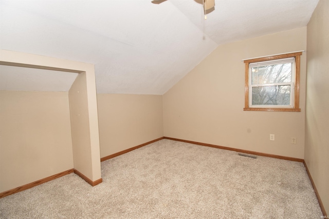 bonus room featuring baseboards, ceiling fan, lofted ceiling, and light colored carpet