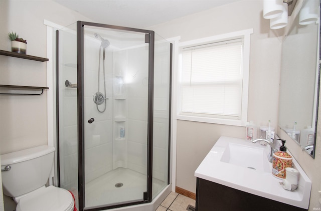 bathroom featuring toilet, a shower stall, tile patterned flooring, and vanity