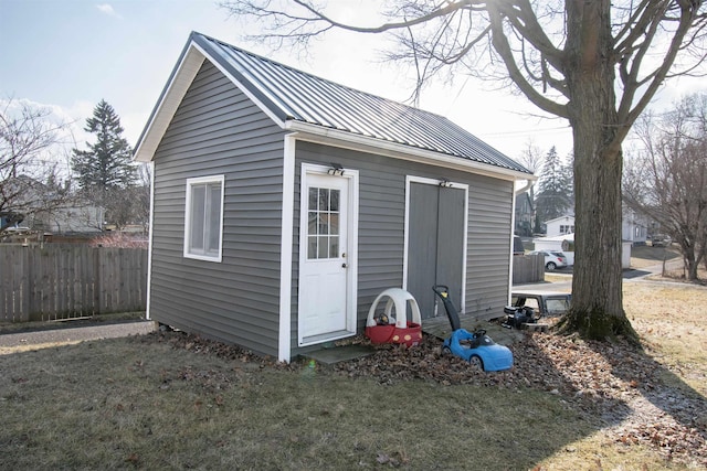 view of shed featuring fence