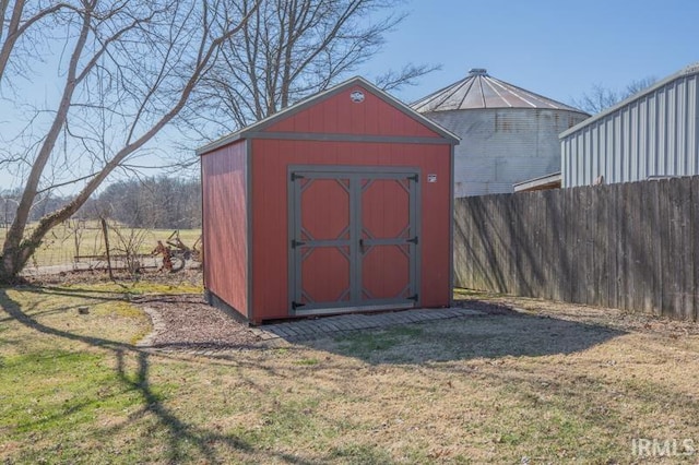 view of shed featuring fence