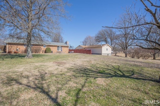 exterior space with fence and a front yard