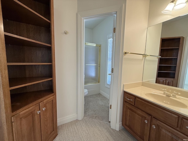 full bath featuring baseboards, toilet, tile patterned flooring, combined bath / shower with glass door, and vanity