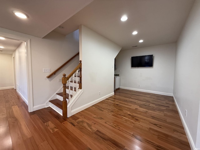 interior space featuring recessed lighting, stairway, baseboards, and wood finished floors