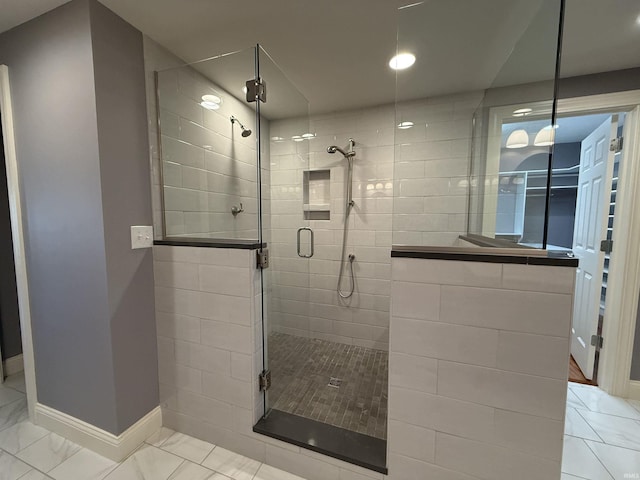 full bathroom featuring a stall shower and baseboards