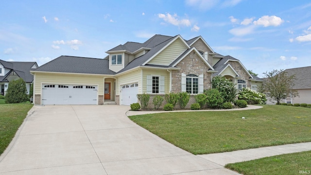 craftsman-style house with a front yard, stone siding, driveway, and an attached garage