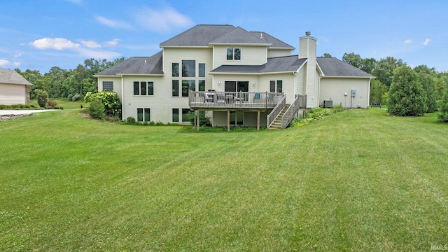 rear view of property featuring a deck, cooling unit, stairs, a yard, and a chimney