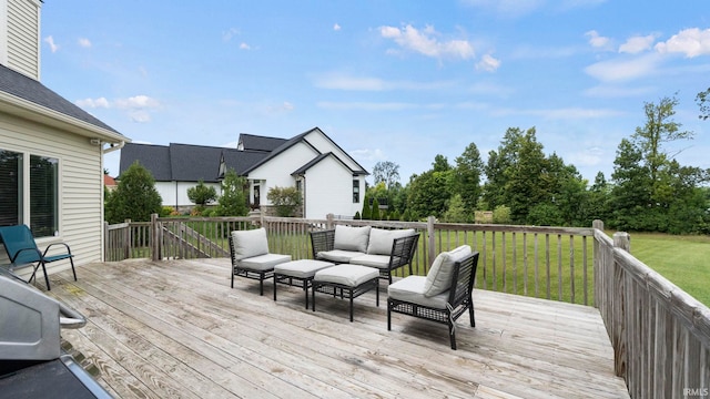 wooden deck with an outdoor living space and a lawn