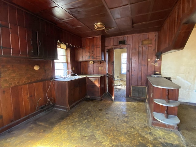 2524 Diefenbach Rd, Evansville, IN 47720 - kitchen featuring wood walls, visible vents, light countertops, and a sink