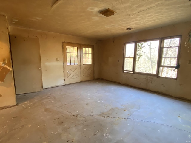 2524 Diefenbach Rd, Evansville, IN 47720 - empty room featuring a wealth of natural light and unfinished concrete floors