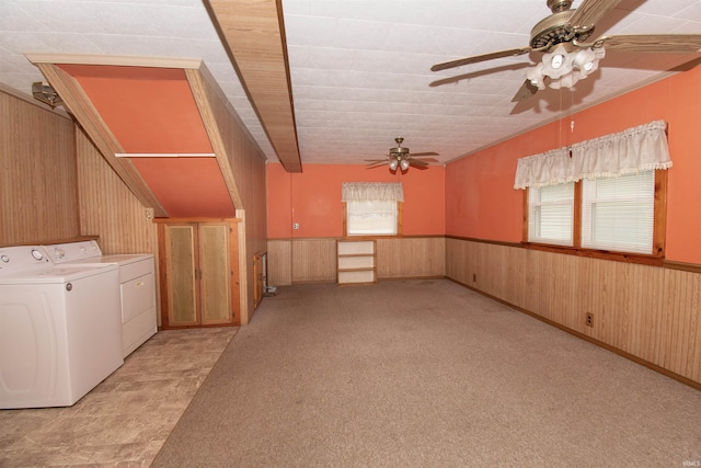 spare room featuring wooden walls, a wainscoted wall, washer and clothes dryer, and light carpet