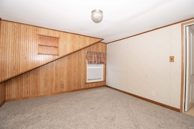 spare room with wood walls and light colored carpet