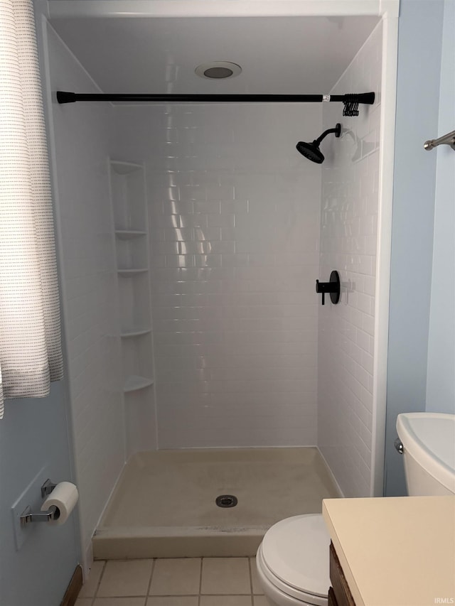 full bathroom with toilet, a stall shower, vanity, and tile patterned floors