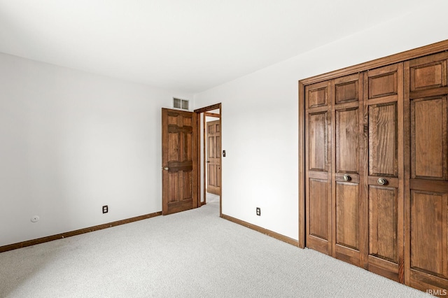 unfurnished bedroom with light carpet, baseboards, and visible vents