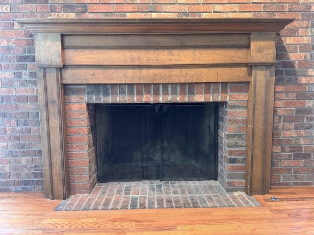 room details featuring a fireplace and wood finished floors