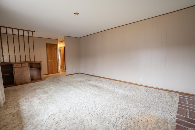 unfurnished living room with baseboards