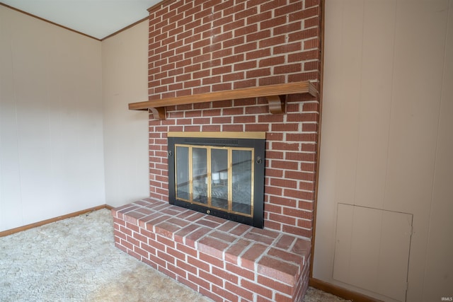 details featuring carpet floors, a fireplace, baseboards, and ornamental molding