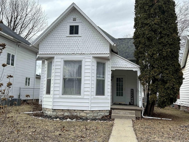 victorian-style house with roof with shingles