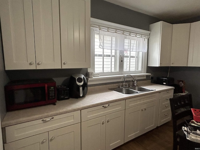 kitchen featuring white cabinets and a sink