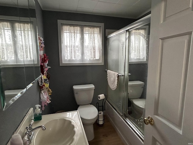 full bath with a wealth of natural light, a sink, and toilet