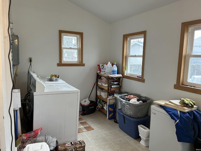 washroom with electric panel, laundry area, light tile patterned floors, and separate washer and dryer