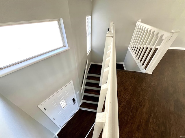 stairway featuring baseboards and wood finished floors