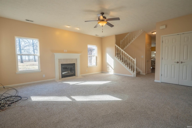 unfurnished living room with stairs, baseboards, and carpet flooring