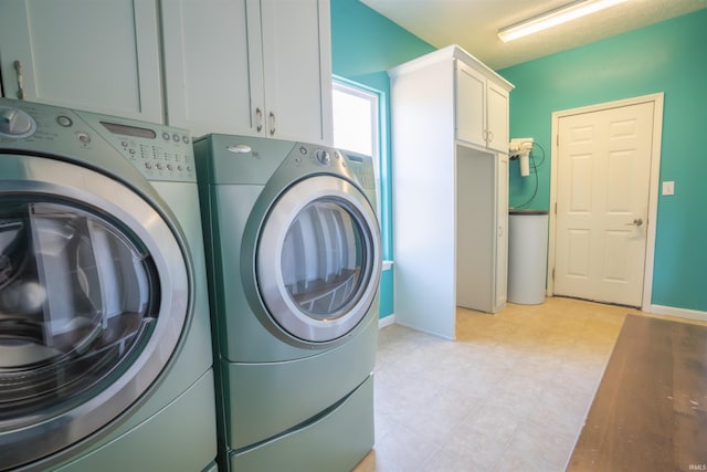 washroom featuring cabinet space and washing machine and dryer