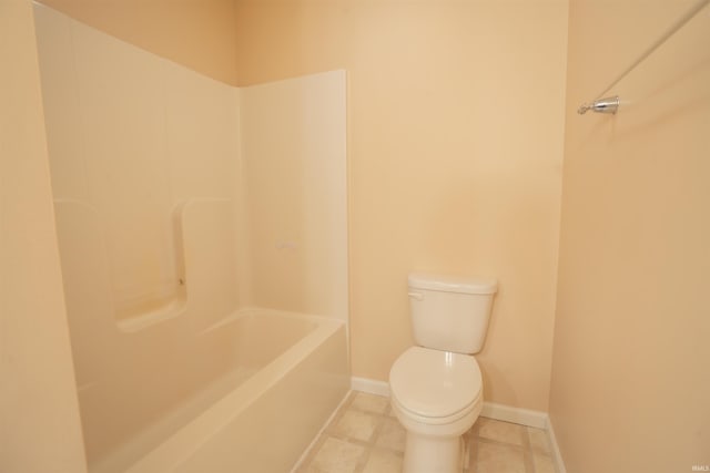 bathroom with toilet and baseboards