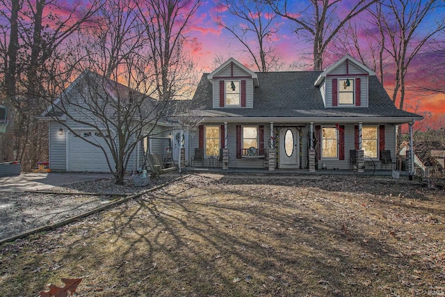 view of front of property with driveway, a porch, roof with shingles, and an attached garage