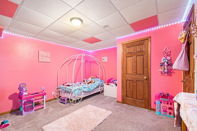 bedroom featuring carpet floors, a paneled ceiling, and baseboards