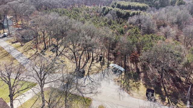 birds eye view of property featuring a view of trees