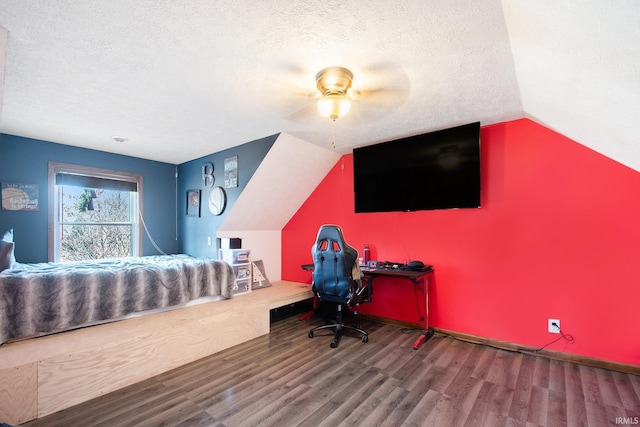 office featuring lofted ceiling, a textured ceiling, and wood finished floors