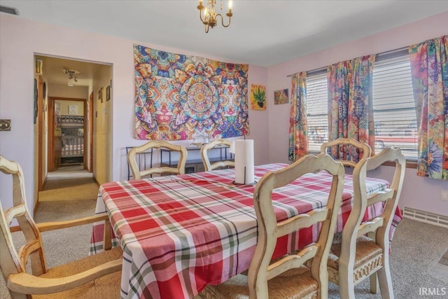 carpeted dining room featuring a chandelier and visible vents