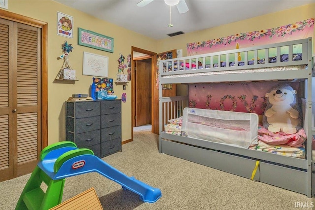 carpeted bedroom featuring a ceiling fan, visible vents, and a closet