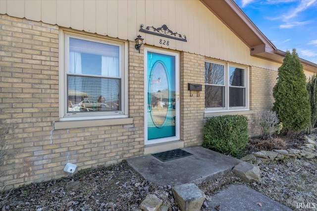 property entrance with brick siding