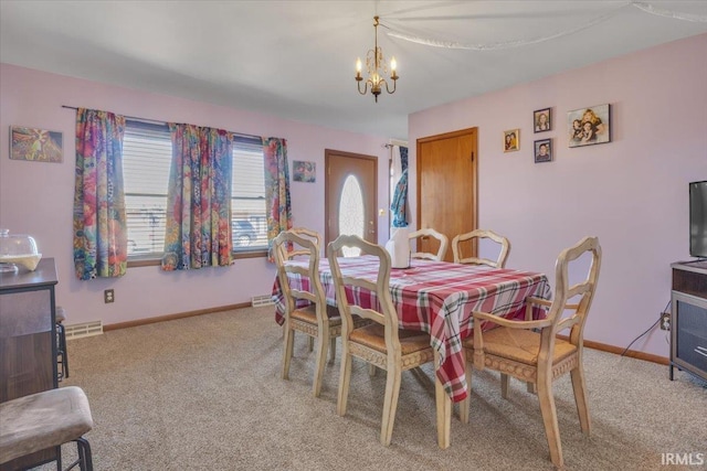 dining room with baseboards, an inviting chandelier, visible vents, and light colored carpet