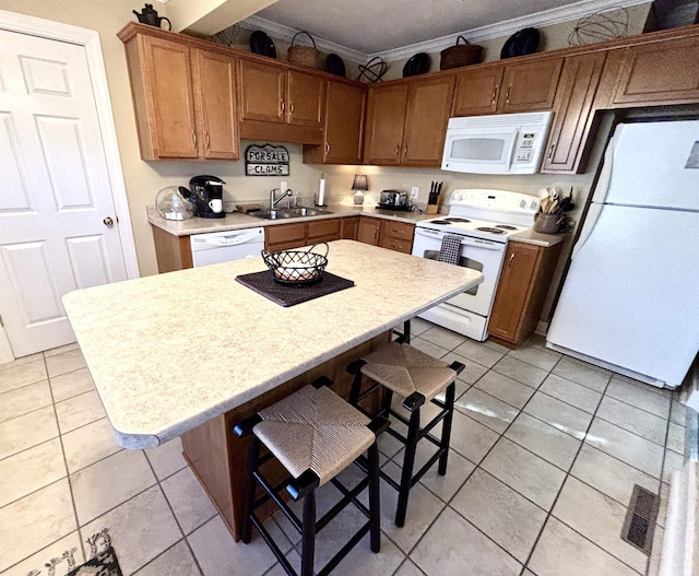 kitchen featuring ornamental molding, white appliances, light countertops, and a sink