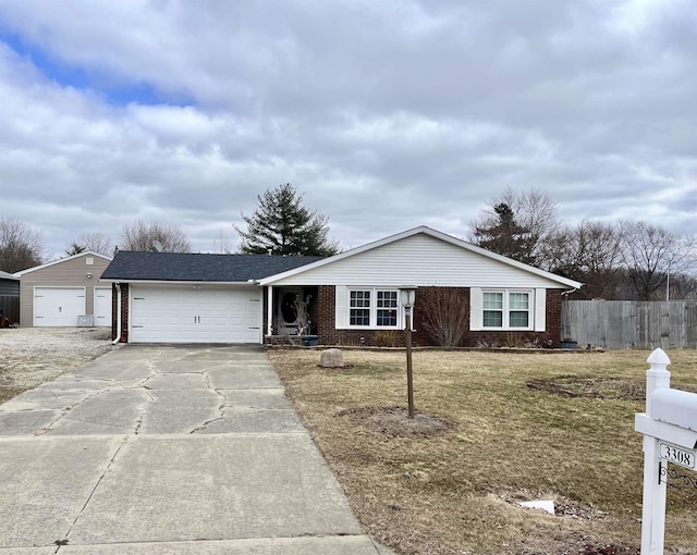 ranch-style home featuring a garage, brick siding, fence, driveway, and a front lawn