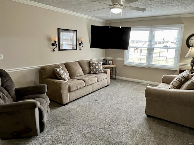 carpeted living room featuring a ceiling fan, baseboards, ornamental molding, and a textured ceiling