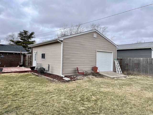 detached garage with fence and driveway