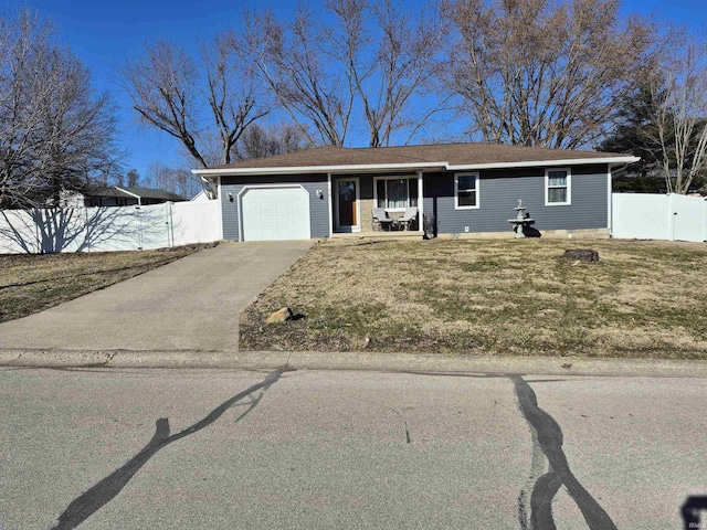 view of front of house with aphalt driveway, a front lawn, fence, and a garage