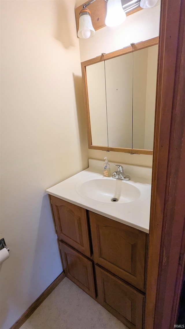 bathroom with vanity and baseboards