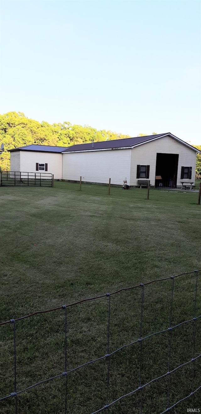 exterior space with a lawn and fence