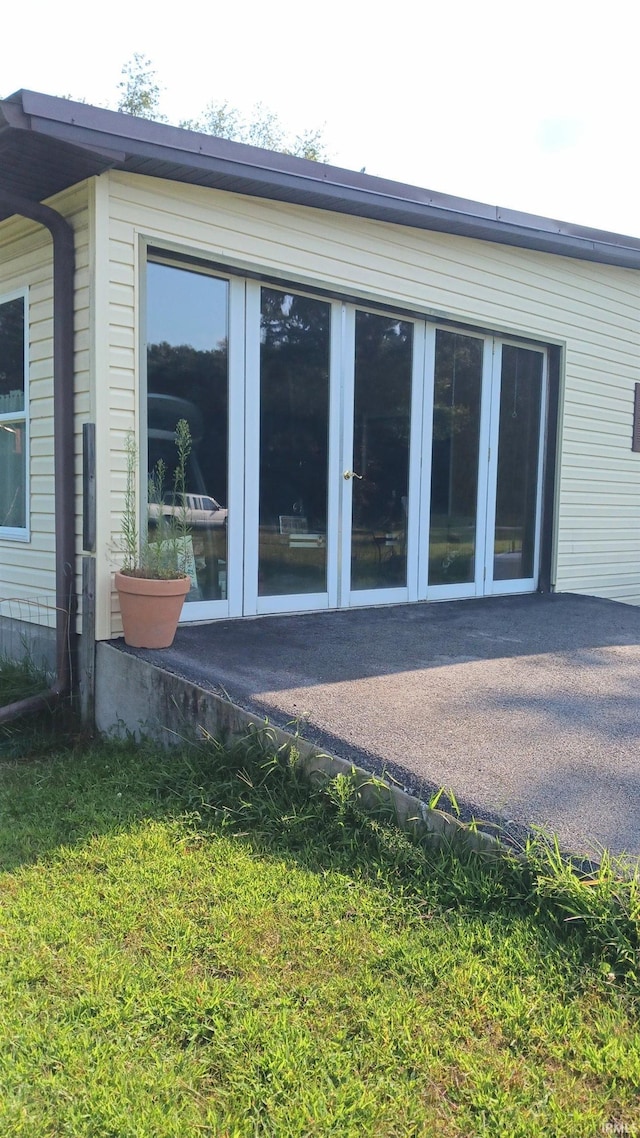 view of side of property featuring a patio area and french doors