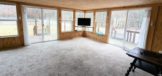 unfurnished sunroom with wood ceiling