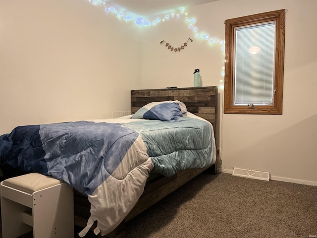 carpeted bedroom featuring visible vents and baseboards