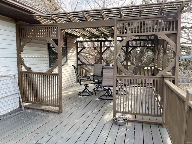 deck with a pergola and outdoor dining space