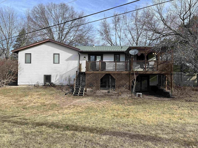 back of house with a yard, fence, metal roof, a deck, and stairs