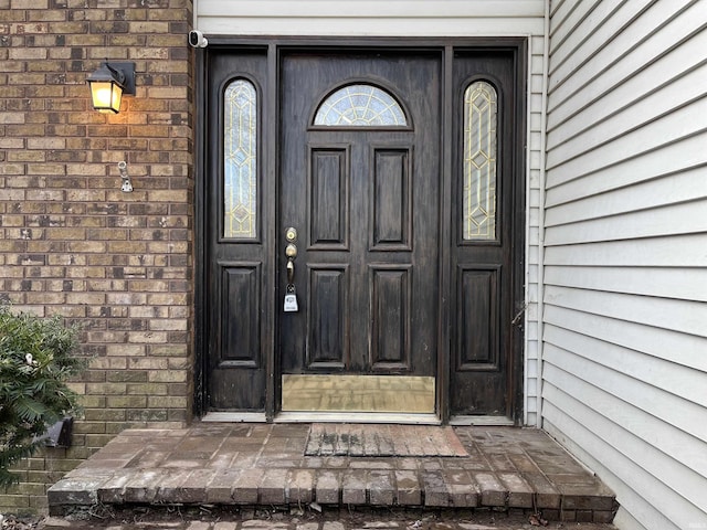 property entrance with brick siding